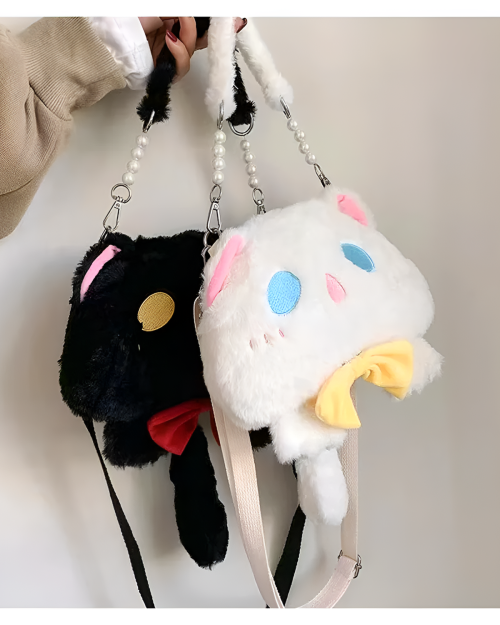 Close-up of a black and white Kawaii Phantom Neko Bag with pearl straps, showcasing the cat-shaped plush design.