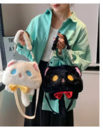 Woman wearing a light green shirt and holding a black and white Kawaii Phantom Neko Bag with cat ears and a red bow.