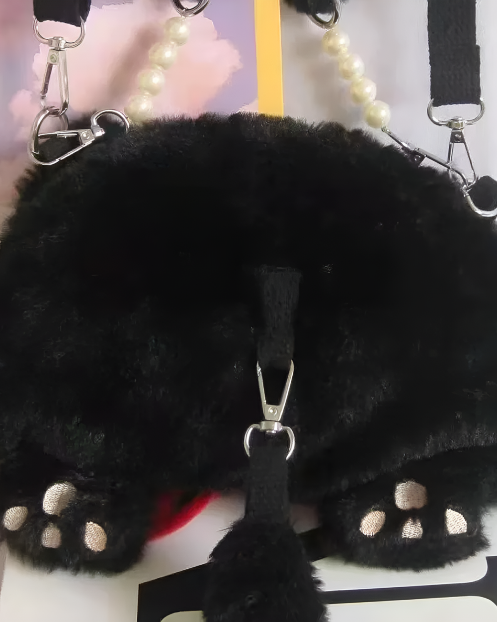 Close-up of the Kawaii Phantom Neko Bag, a black fluffy cat-shaped shoulder bag with pearl and paw details.