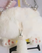 Close-up of a white Kawaii Phantom Neko Bag charm with pink paw pads and a metal clasp.