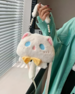 Hand holding a white fluffy Kawaii Phantom Neko Bag with a yellow bow and pearl strap. Close-up shot.