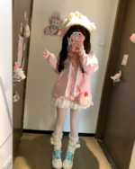 Pink Neko Hoodie worn by a person in a room setting.