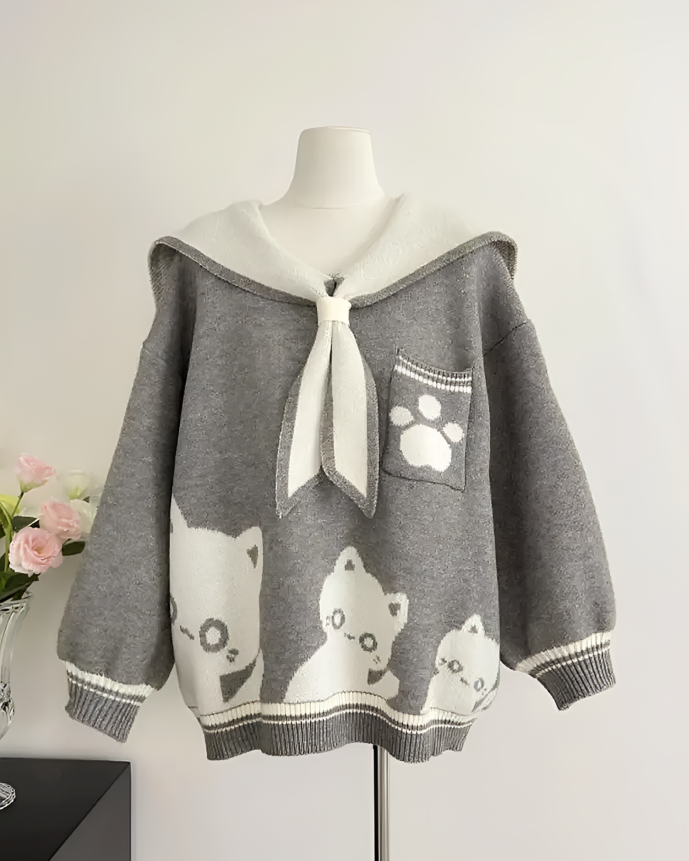 Kawaii Sailor Pullover Sweater on a mannequin, featuring cat embroidery and a bow detail.