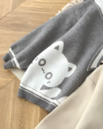Close-up of a Kawaii Sailor Pullover Sweater with a white cat design.