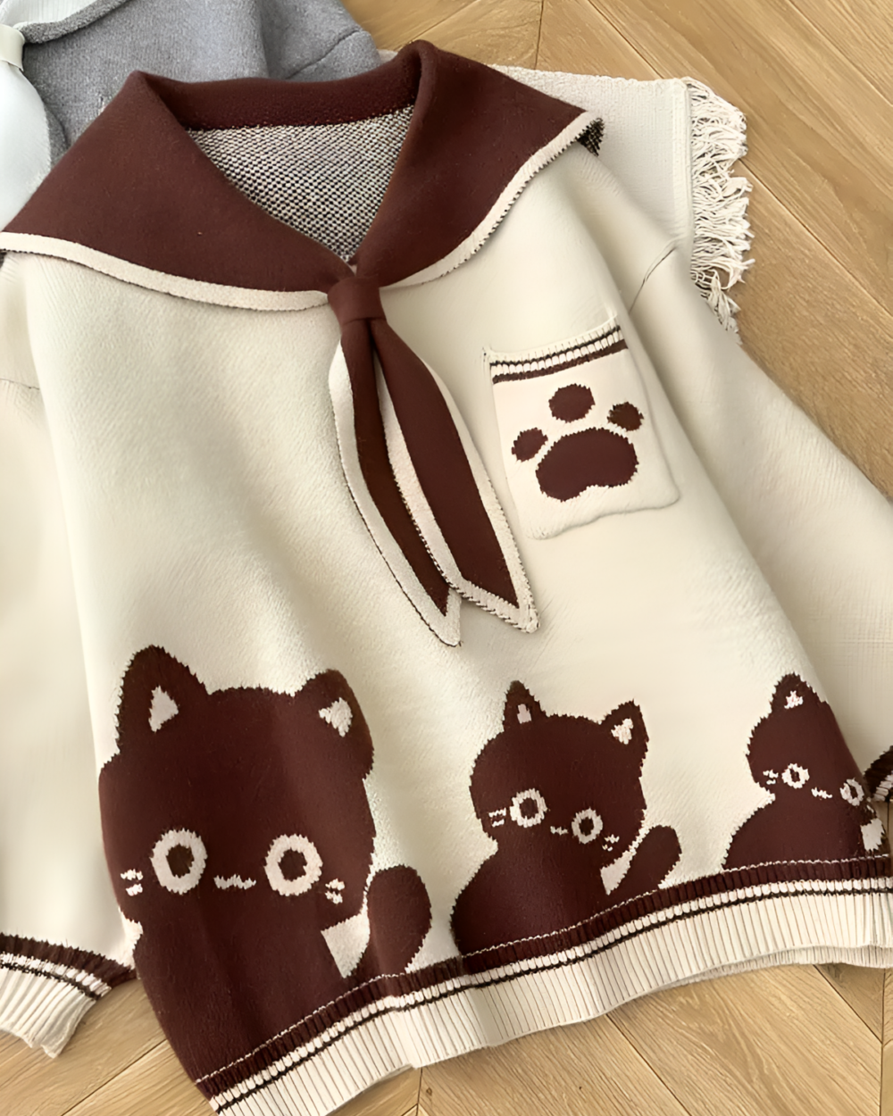 Close-up of a Kawaii Sailor Pullover Sweater featuring a cat design and pocket.