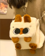 Close-up of a Kawaii Siamese Cat Plush Backpack with big eyes and brown ears.