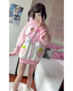 Pink strawberry bunny hoodie worn by a person.