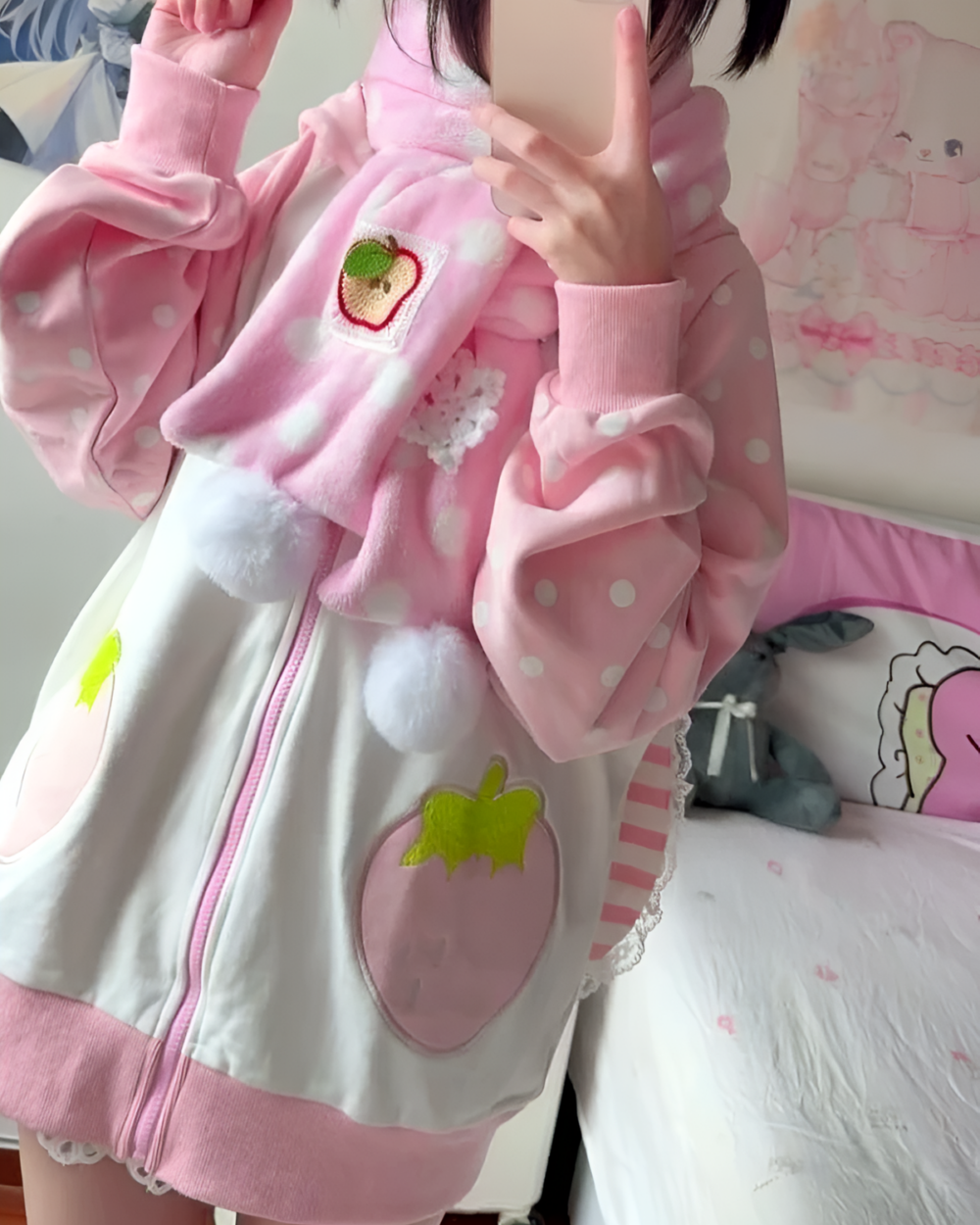 Pink strawberry bunny hoodie with polka dots and plush accents, worn by a person.