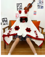 A person wearing a red and white Kawaii Winged Eared Plush Cape with paw prints and ribbon details, seated with a violin.