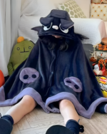 Child wearing a dark blue Kawaii Winged Eared Plush Cape with tentacle details and a hooded design. Plush toys are visible in the background.