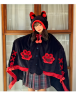 A person wearing a black Kawaii Winged Eared Plush Cape with red accents and paw prints. The cape has a hood with ears.