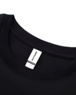 Close-up of a black Chaos Neko Explosion Tee showing the neck label and fabric texture.