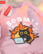 Close-up of a pink tee with a graphic of a chaotic cat and text. Featuring the Chaos Neko Explosion Tee design.