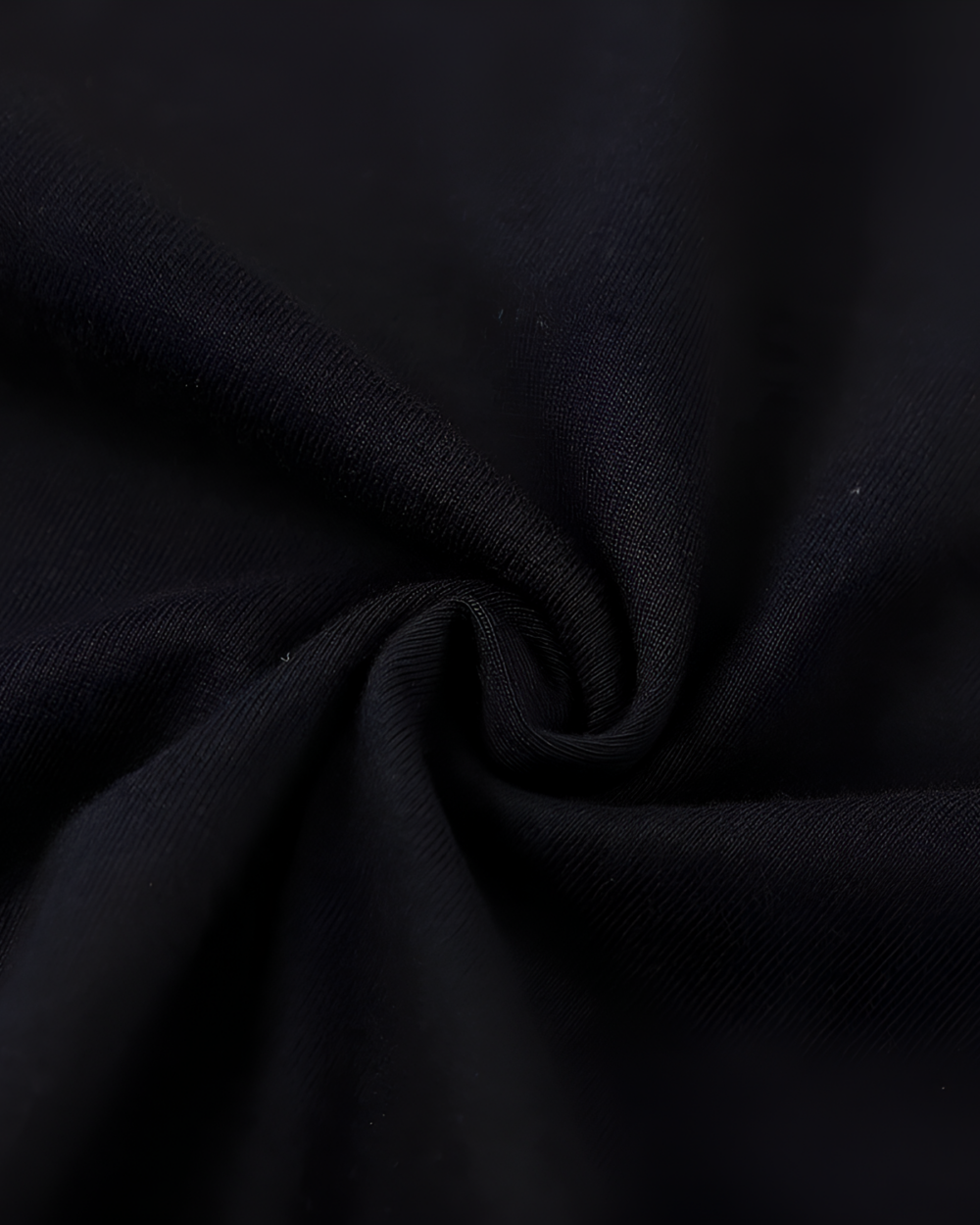 Close-up of black fabric texture for the Chaos Neko Explosion Tee. Soft material detail.