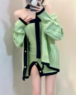 Green chunky knit dress with black accents and a cold-shoulder design.