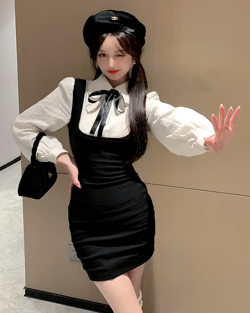 Woman wearing a black Korean preppy mini dress with a white shirt and suspenders.