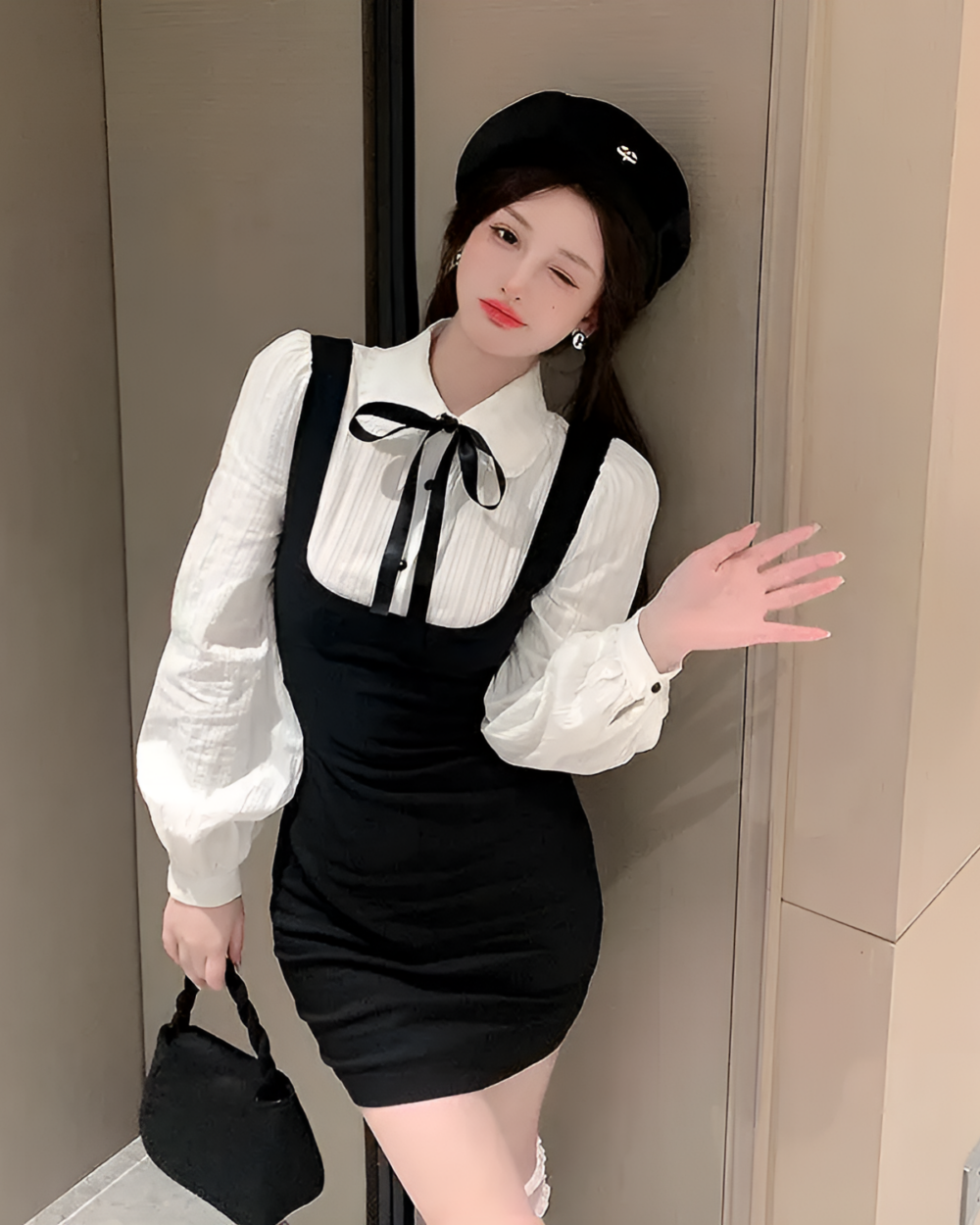 Woman wearing a Korean preppy mini dress with a button-down shirt and overalls.