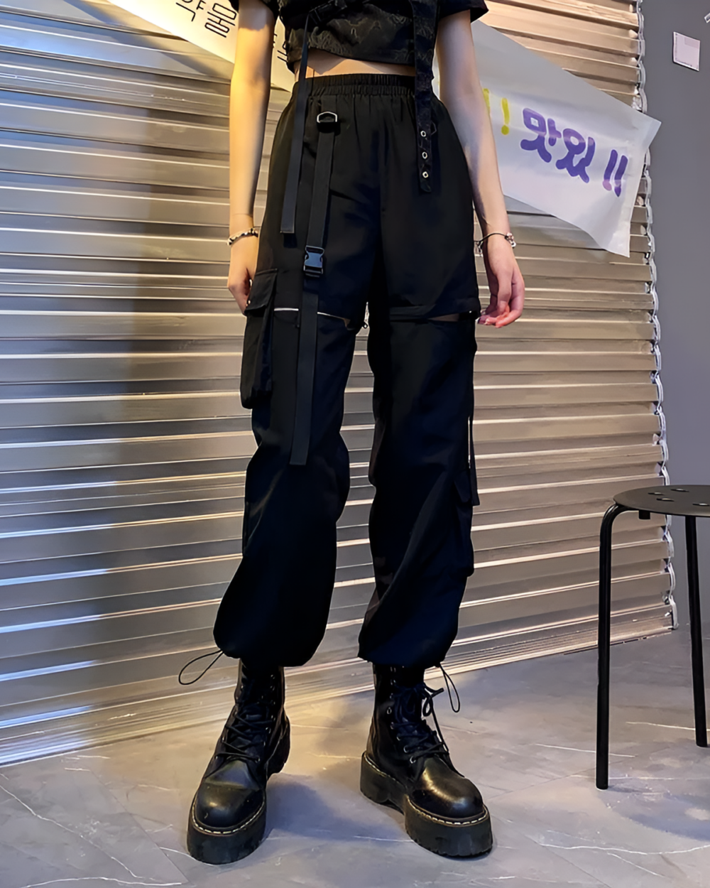 Black Korean style cargo pants with adjustable straps and buckles.