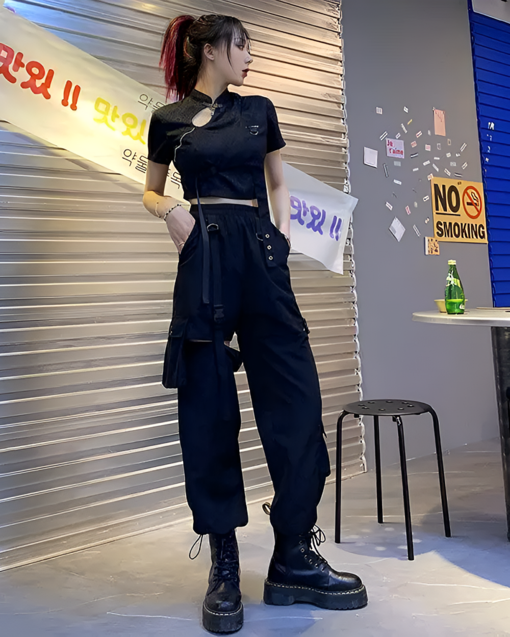 Woman wearing Korean style cargo pants with detachable straps and a crop top.