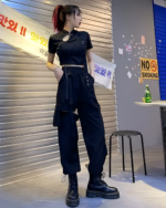 Woman wearing Korean style cargo pants with detachable straps and a crop top.
