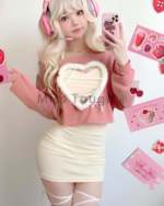 Woman wearing a pink Korean style mini dress coord with heart-shaped details. Perfect aesthetic fashion.
