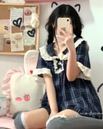 Model wearing Korean style pajamas, a blue plaid sleep set with lace trim details.