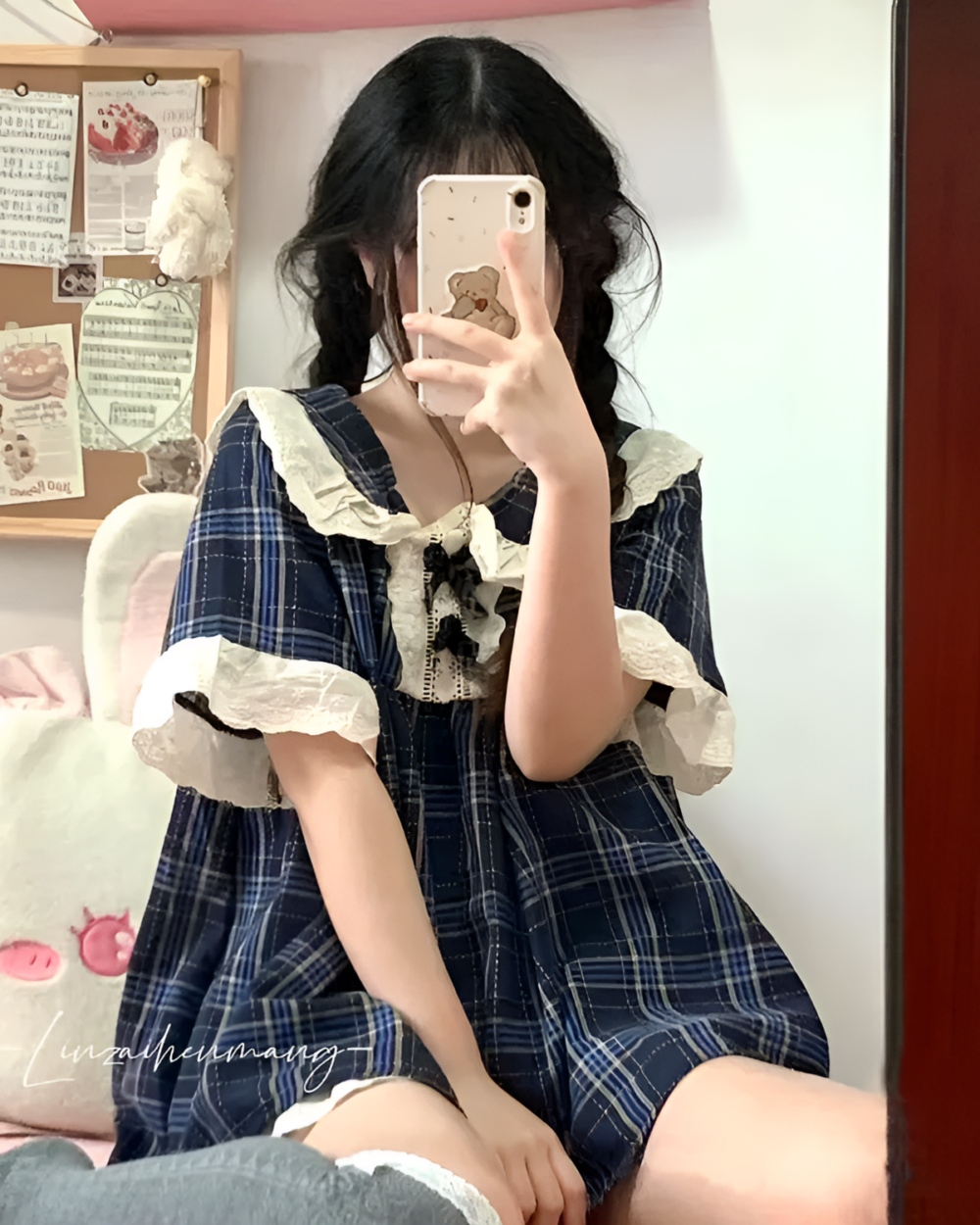 Woman wearing Korean style pajamas with a plaid pattern, featuring ruffled sleeves and a delicate lace detail.