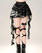 Black and white plaid goth punk skirt with lace and chain details, paired with a leg garter.