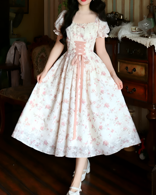 Floral lace-up cottagecore dress in pink and white, featuring a gathered skirt and puff sleeves.