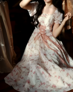 Floral cottagecore dress in pink and white, featuring a ruffled bodice and bow detail.