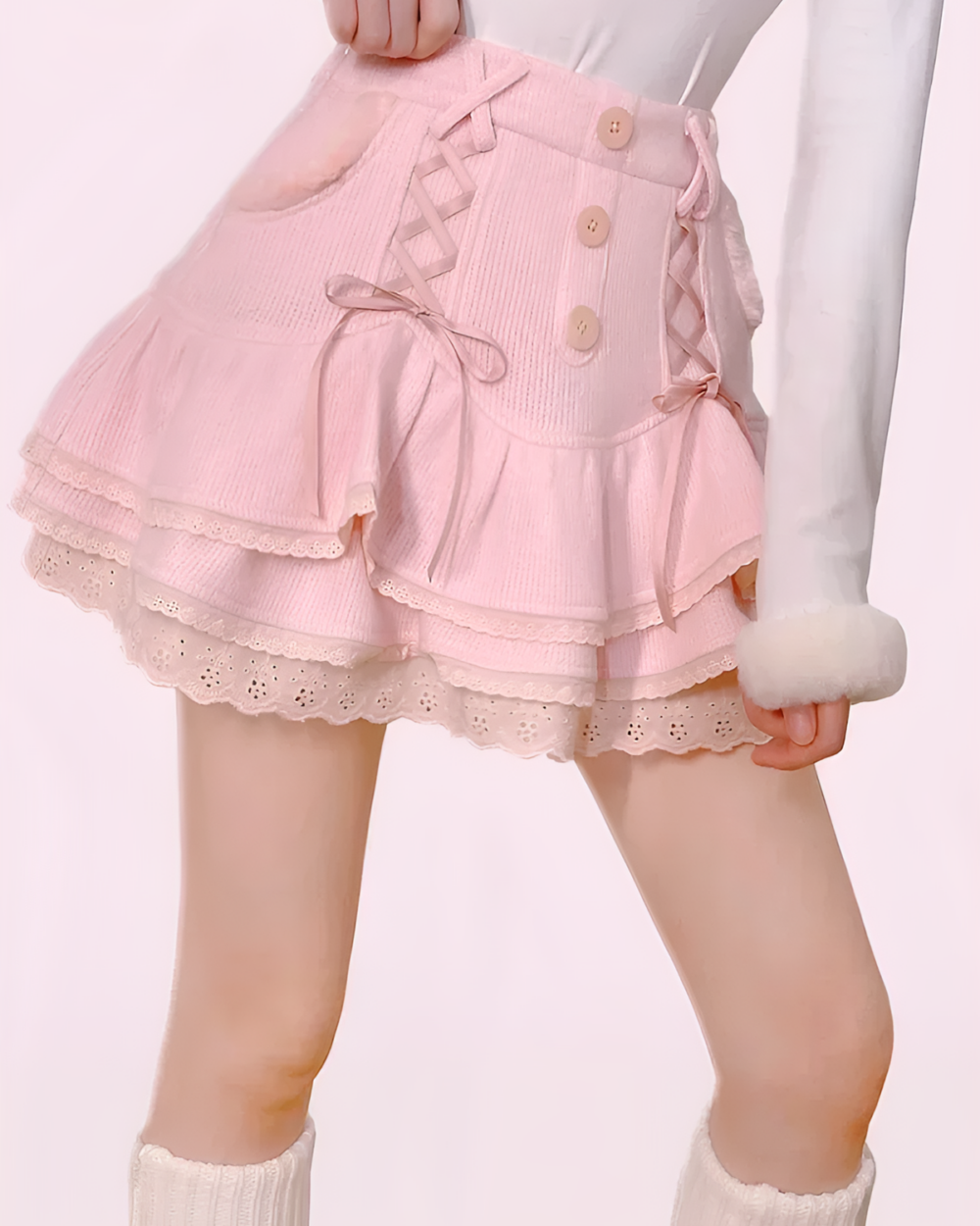 Laced and Ruffled Pink Mini Skirt featuring ruffles and button details.