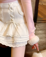 White laced and ruffled pink mini skirt with bow detail.