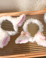 Two fluffy white lamb ears headband with pink inner ears and small bells. A cute lamb ears headband accessory.