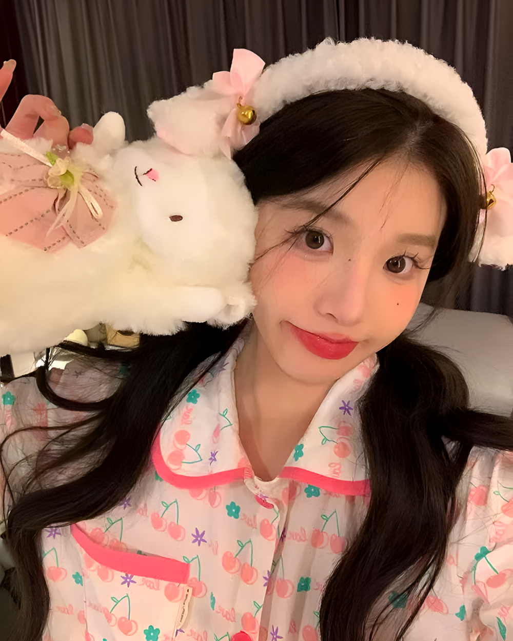 Woman wearing a fluffy white lamb ears headband with a pink bow and bell. A cute lamb ears headband accessory.