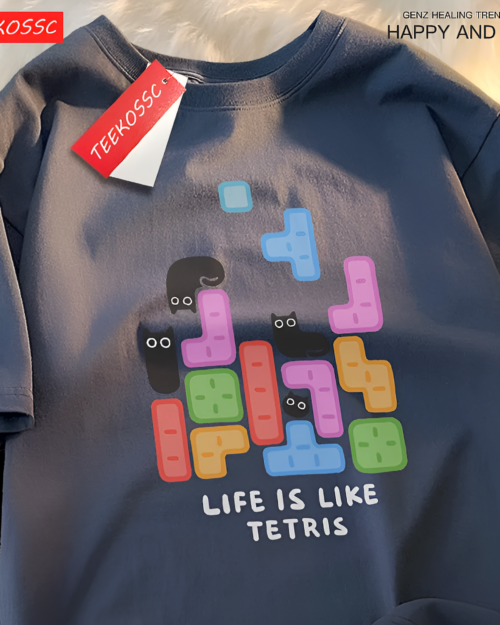 Black t-shirt with a graphic of Tetris blocks forming a cat face. Featuring a "Life is Like Tetris" design, this is a Kuro Neko T-Shirt.