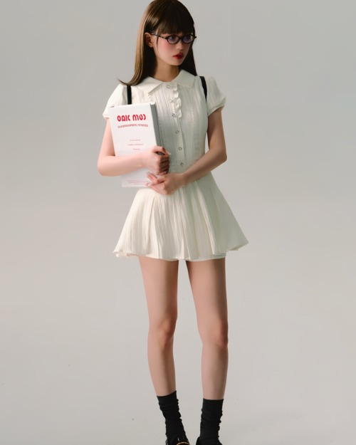 Model wearing an academic aesthetic dress, Literature Girl Mini Dress, holding a book.