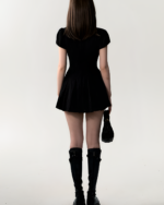 Black Literature Girl Mini Dress, a short academic aesthetic dress, worn by a model.