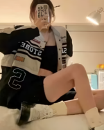 A black and white Long Sleeve Racing Cardigan with a number 2 is worn by a person.