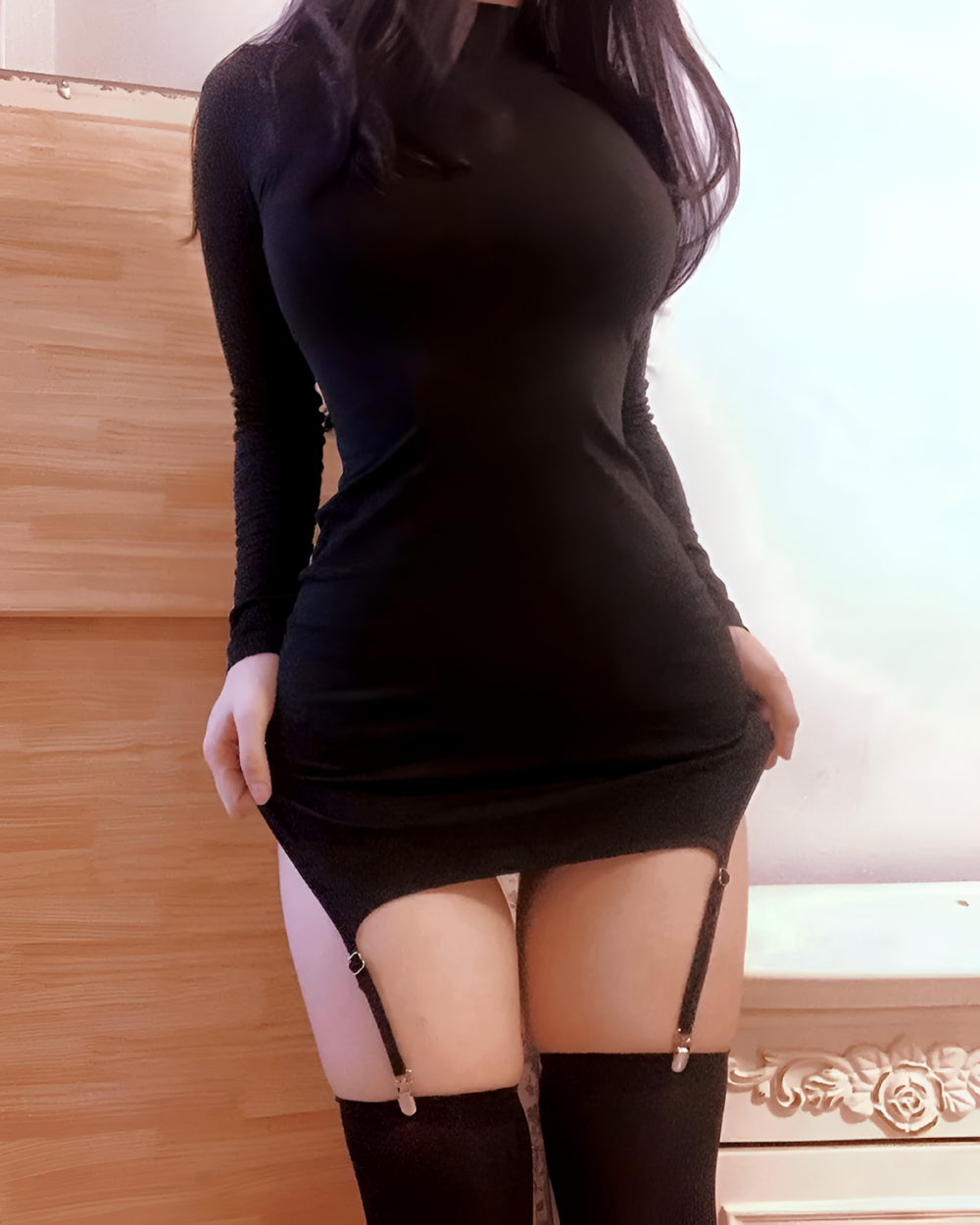 Long sleeve coquette mini dress featuring a high neck and gathered skirt with suspender straps.