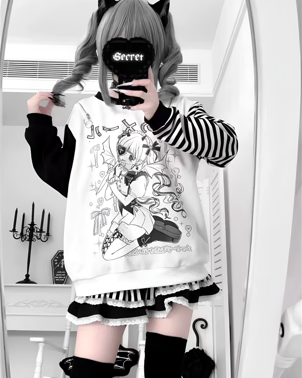 Model wearing a yami kawaii aesthetic long sleeved striped t-shirt with anime character print.