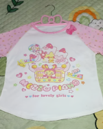 Pink long sleeve Mezzo Piano cake T-shirt with a cute graphic design, hanging on a pink hanger.