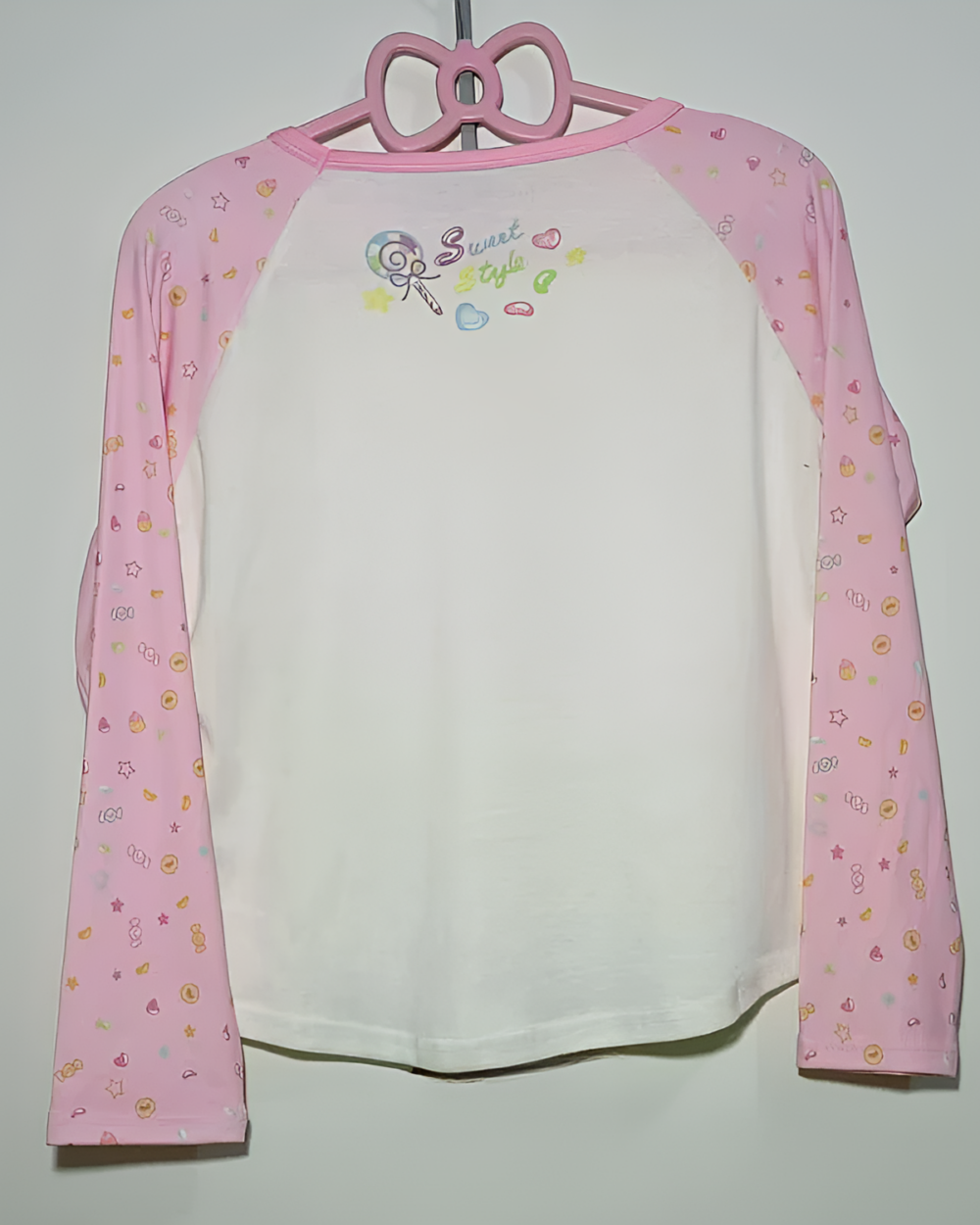 Pink and white long sleeve Mezzo Piano cake T-shirt for kids with a sweet style graphic and cake details.