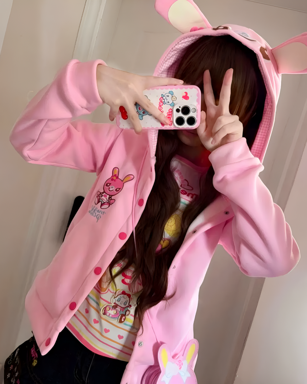 Mezzo Piano Pink Hoodie - Yume Kawaii Aesthetic product photo 1 Woman wearing a pink Yume Kawaii hoodie with bunny ears, showcasing the design and fit.