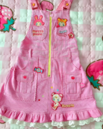 Pink Mezzo Piano dress with embroidered details and a flared skirt. Features a front zipper and decorative patches.