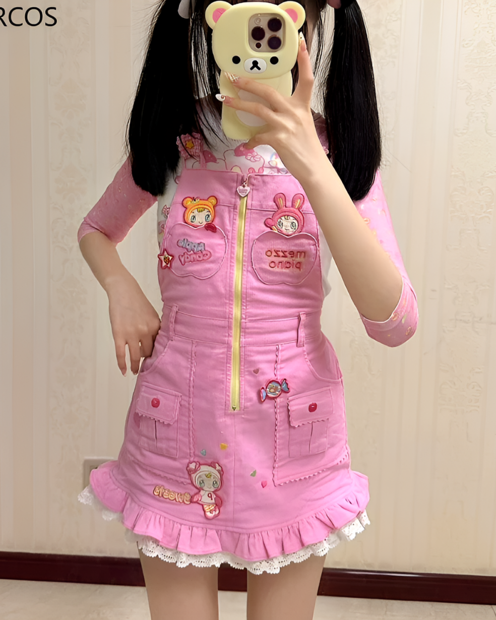 A woman wearing a pink Mezzo Piano dress with bear and bunny details. Jojifuku aesthetic style.