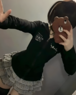 Person wearing a black Midnight Neko Zip Hoodie, a Yami Kawaii hoodie with a graphic design. Taken with a mirror selfie.
