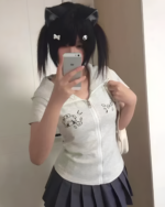 Person wearing a white zip-up Yami Kawaii hoodie with cat ears. The hoodie features a graphic design.