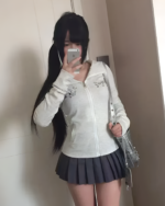 Woman wearing a white Midnight Neko Zip Hoodie, a style of Yami Kawaii hoodie, with a gray skirt.