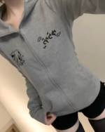Person wearing a gray zip-up Yami Kawaii hoodie with Japanese lettering and a cat illustration.