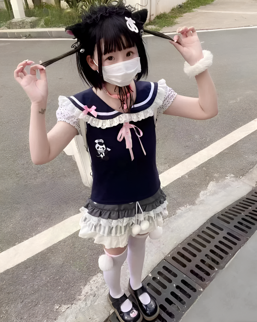Model wearing the Midnight Panda Sailor Tee, a black kawaii t-shirt with panda and sailor collar details.